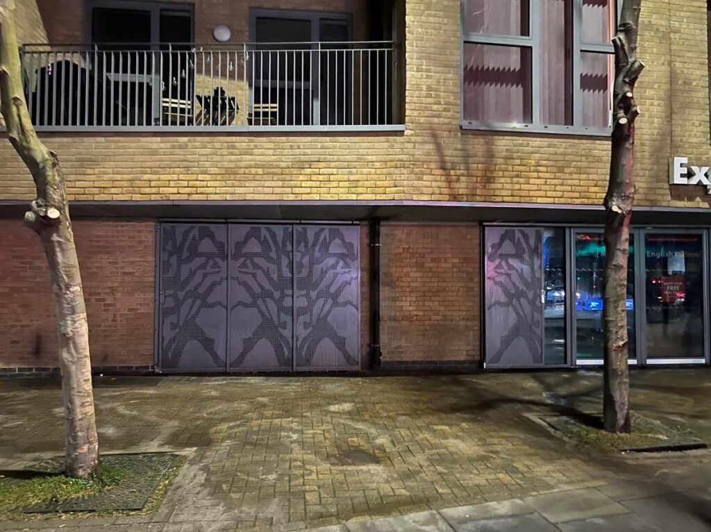 Graffiti-covered building facade in Kent, showcasing professional graffiti removal services by Clearwater Kent, with a focus on effective cleaning methods for commercial properties.